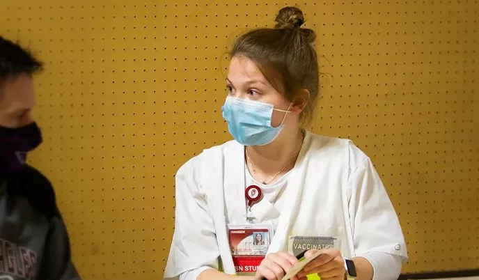 A nursing student speaking with a community member