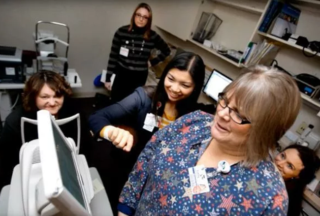 Dr. Yao Liu and staff look at an image from an eye camera