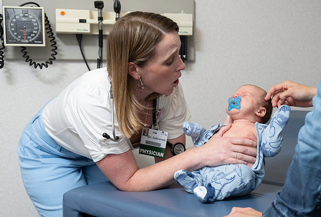 Jenna Sebranek examines an infant