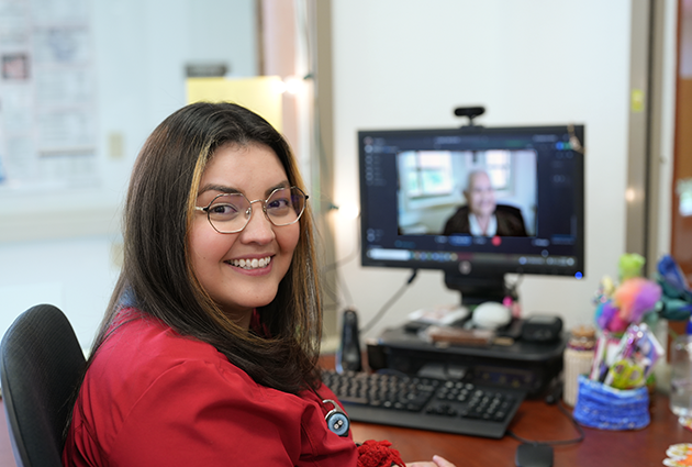 A United Community Center caregiver on a video call with a resident