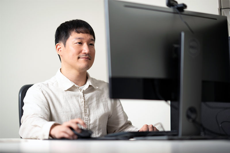 A person sitting at a desktop computer
