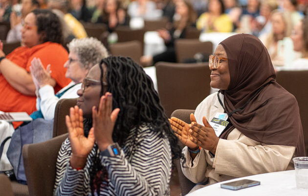 Two women clapping during Fellowship 20th anniversary Celebrations