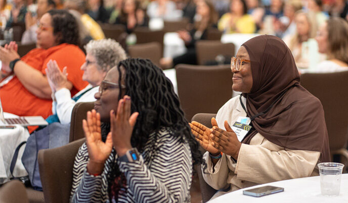 Two women clapping during Fellowship 20th anniversary Celebrations