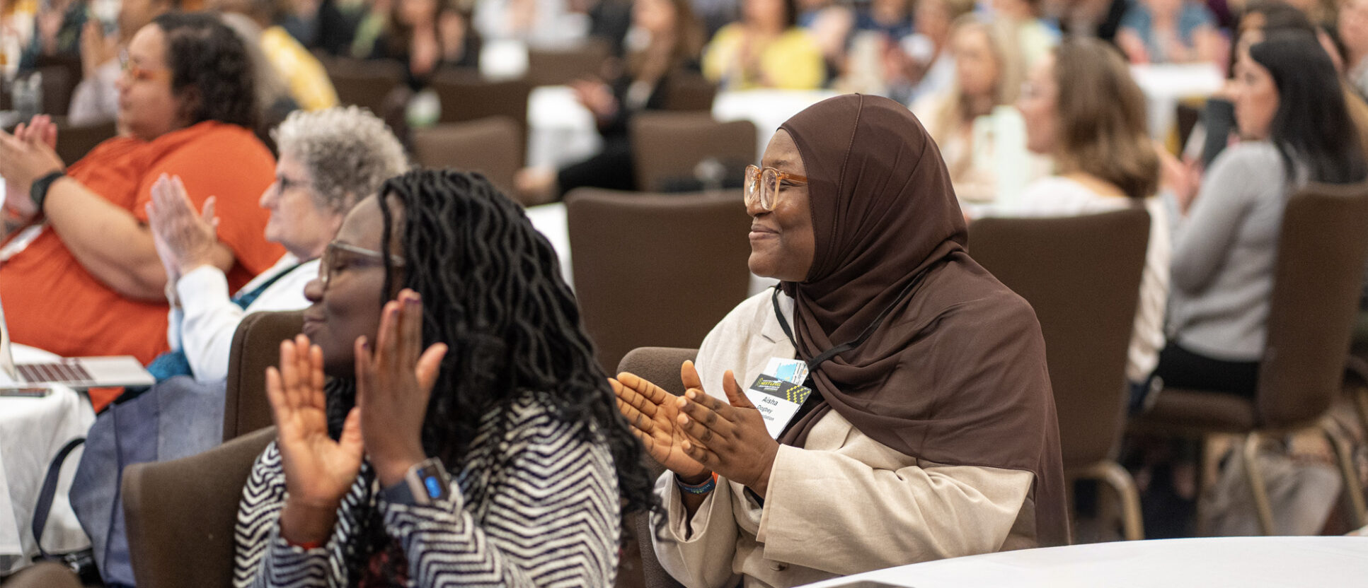Two women clapping during Fellowship 20th anniversary Celebrations