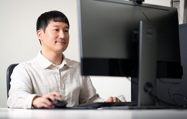A person sitting at a desktop computer