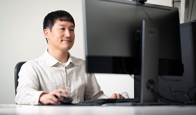 A person sitting at a desktop computer
