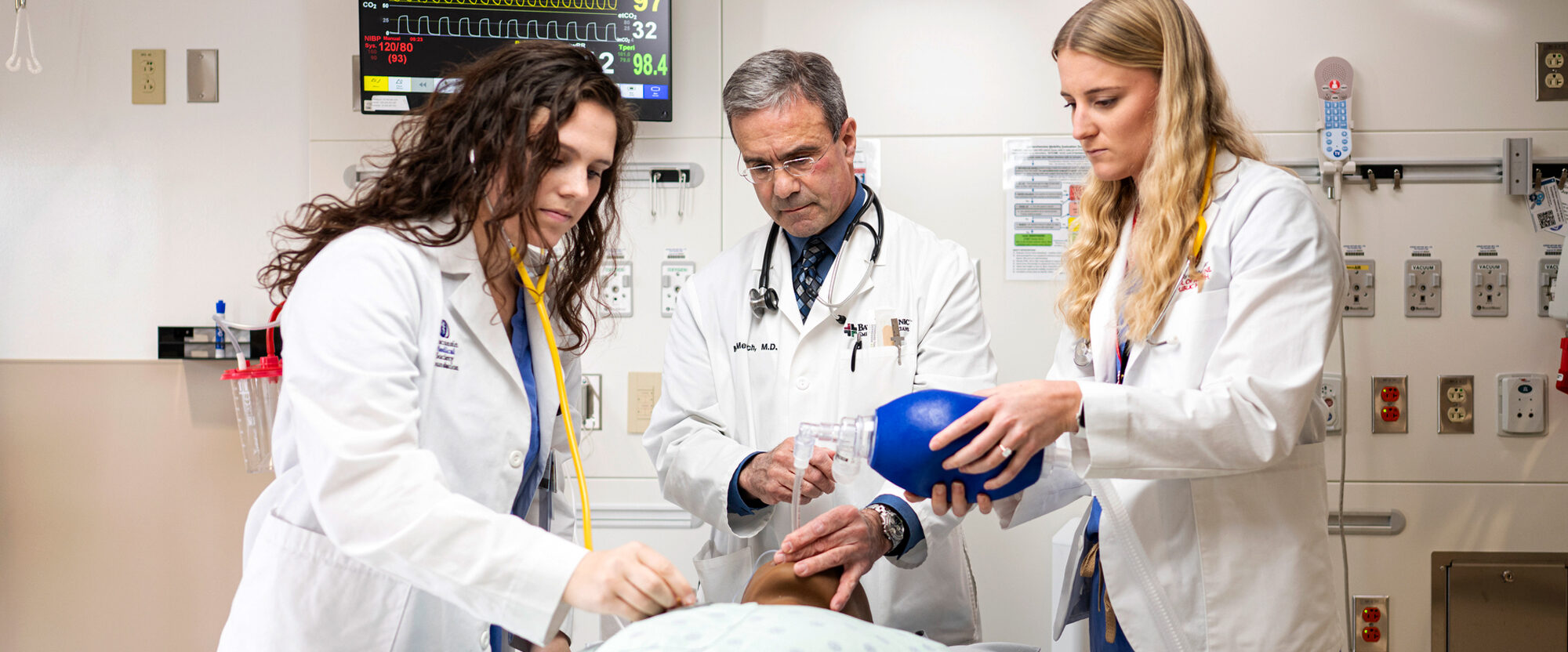 Medical students practice intubattion on a training manikin