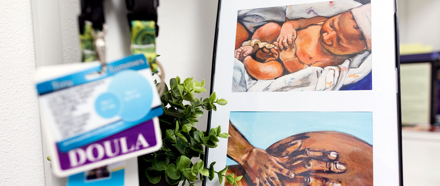 Doula nametag with a painting of a newborn baby