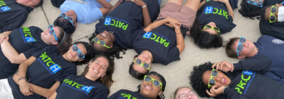 PATCH teams laying on the ground with heads together