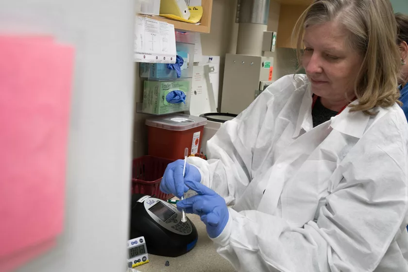 A health care worker testing a nasal swab to detect infection