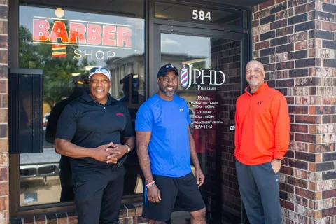 Aaron Perry, Jeff Patterson and J.C. Dawkins outside a barbershop